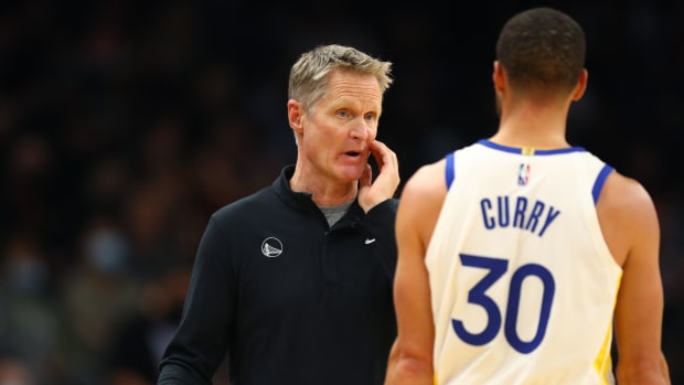 Nov 30, 2021; Phoenix, Arizona, USA; Golden State Warriors head coach Steve Kerr with guard Stephen Curry (30) against the Phoenix Suns at Footprint Center.